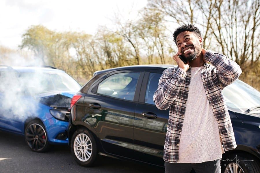 man calling insurance a car accident
