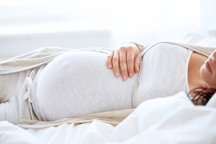 Pregnant Woman Sleeping in Bed at Home