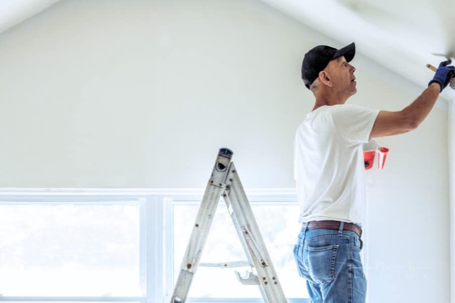 Senior man painting apartment interior