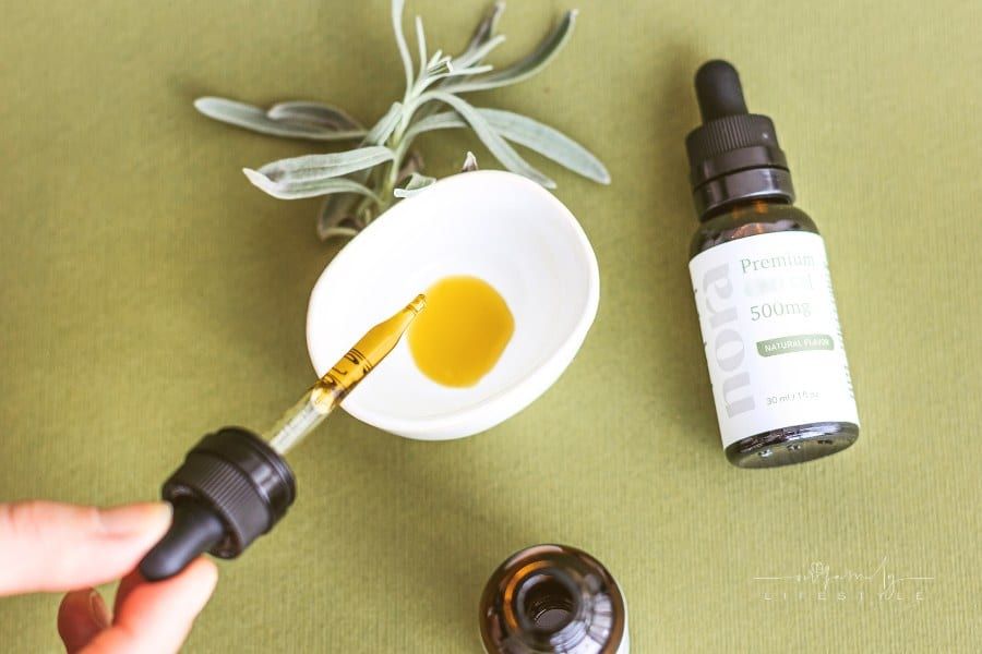 Woman Putting CBD Oil in a Bowl