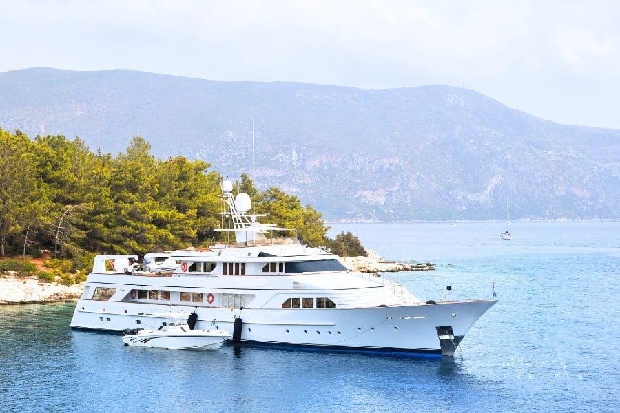 luxury yacht anchored near land penisula