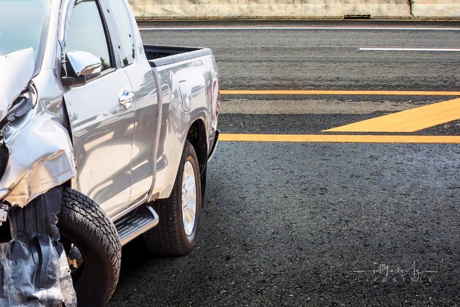 Pickup truck crash damaged from accident on highway road