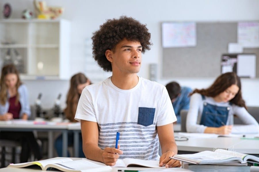 Young Man Daydreaming in Class