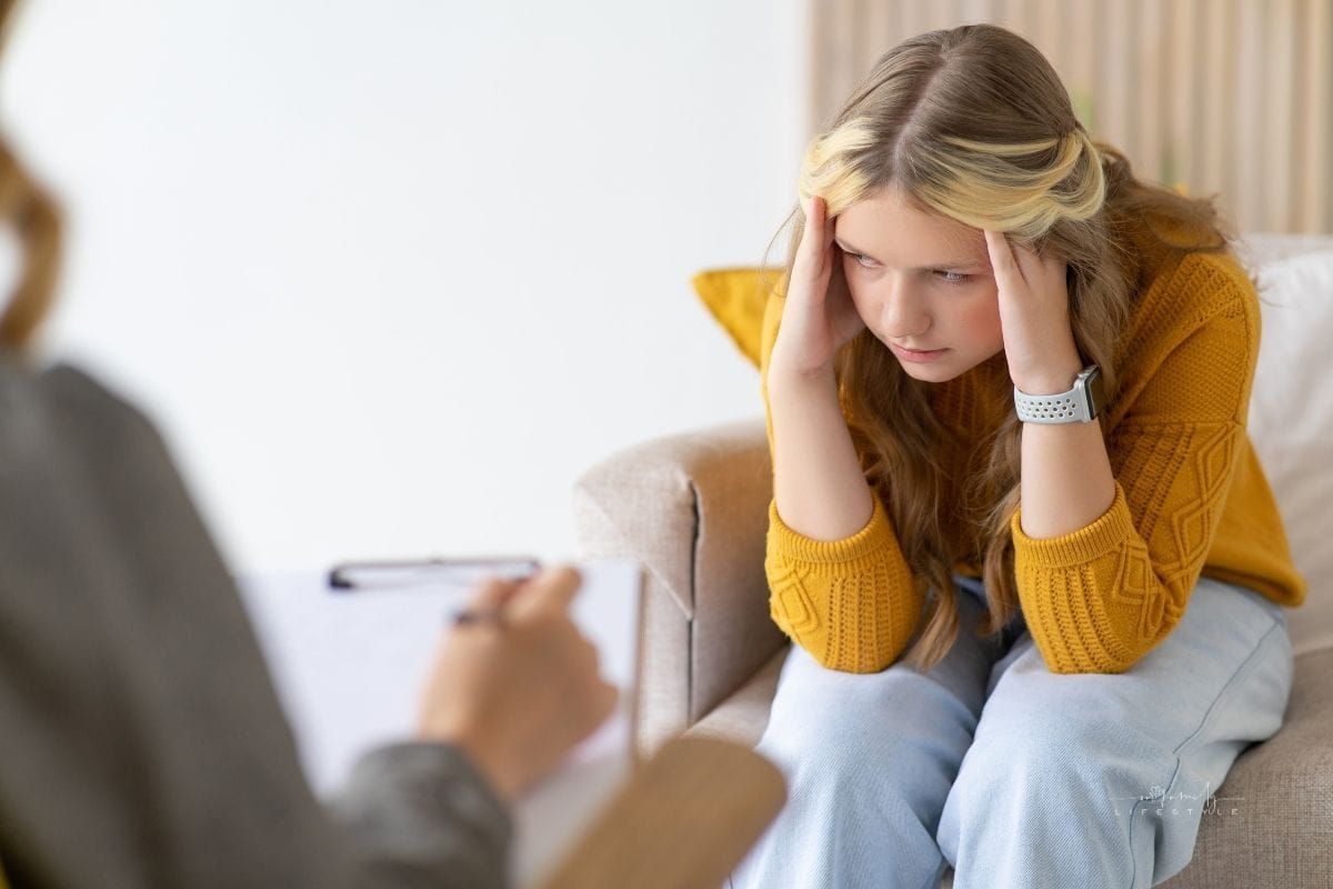 Consultation with a teenage psychologist. Worried sad teenage girl having a session with the doctor.