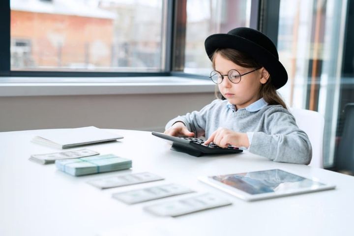 little girl using calculator pretend play