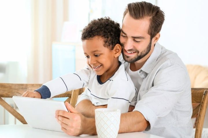 Father with Adopted Boy Using Tablet