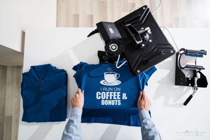 man using heat press for tshirt screen print transfer