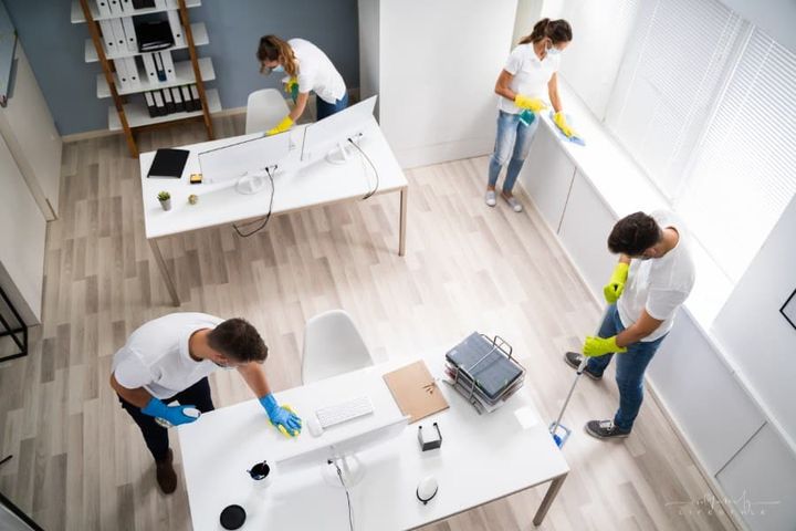 team of professional cleaners cleaning an office space