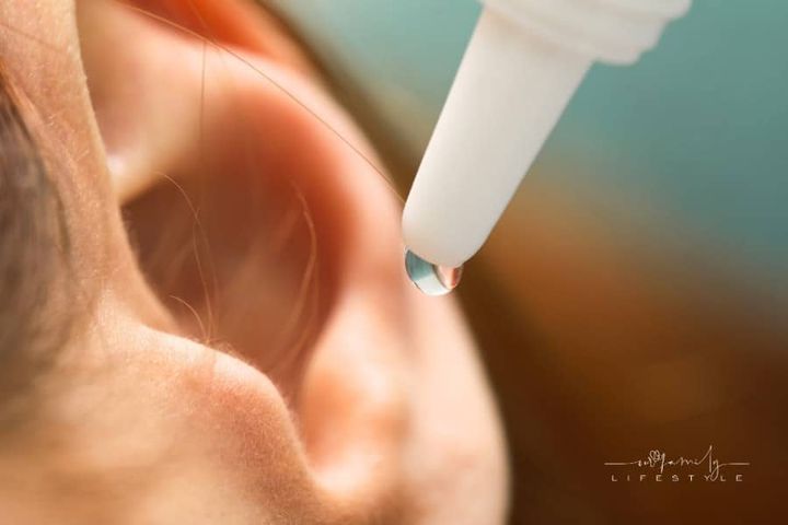 Woman Applying Medical Ear Drops