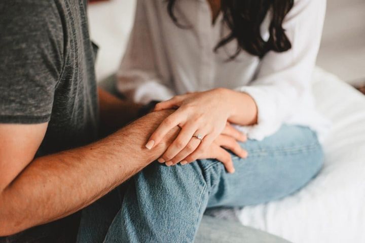 Woman Holding Husband's Hand