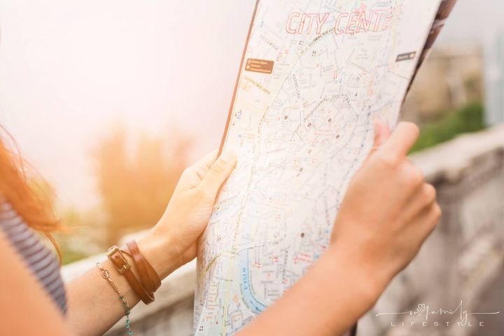 female tourist looking map of city center
