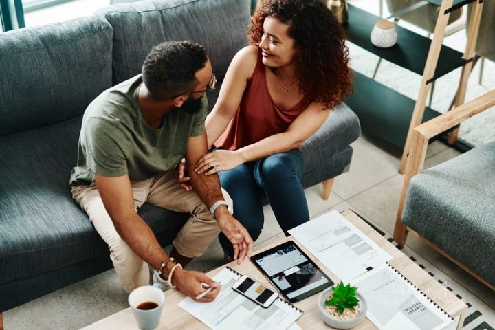 Young couple working on Financial planning to meet their current and future needs