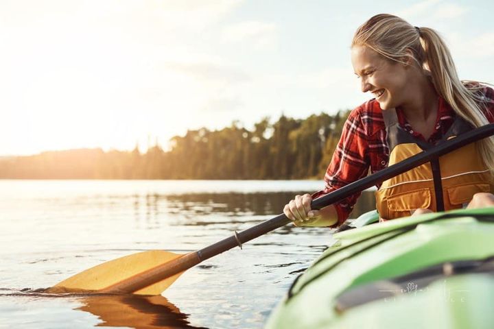 a young woman in a kayak at the lake