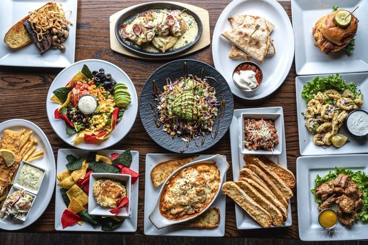 variety of plated meals on a wooden tabletop