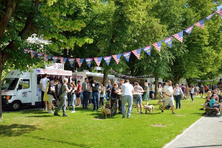 People Having Fun at a Craft Fair with food trucks