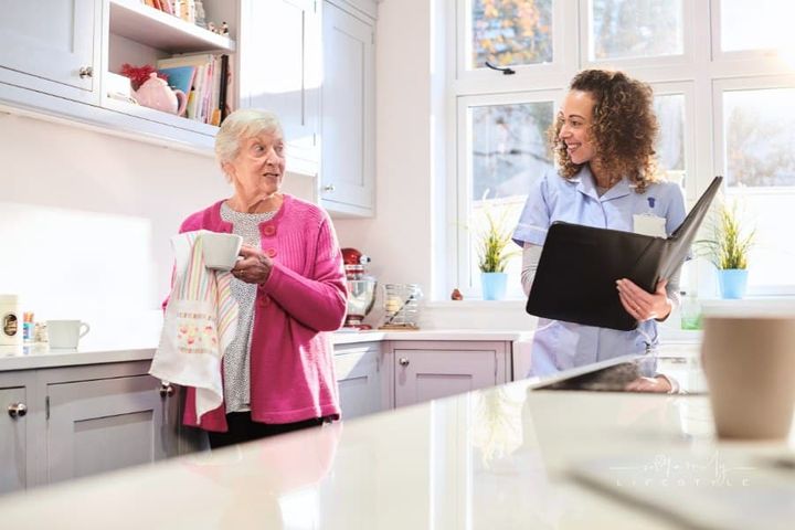 senior woman in assisted living home with female caregiver