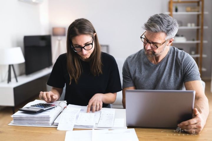 couple looking over receipts while working on family budget