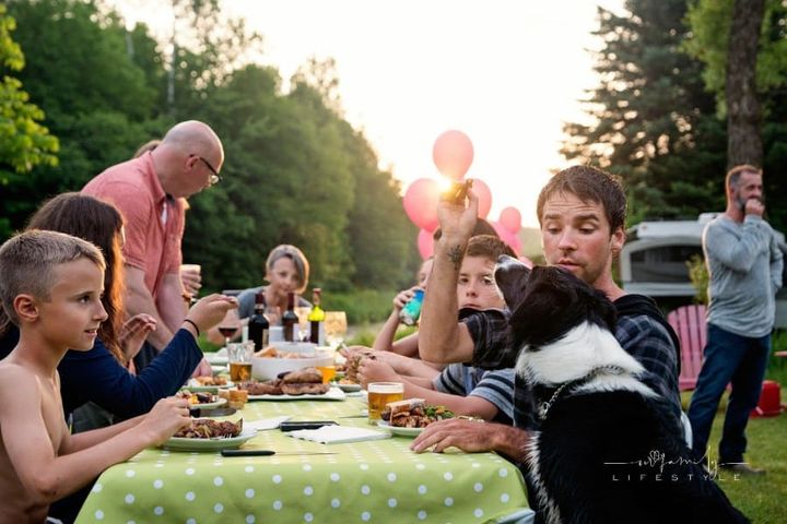 Big family barbecue gathering at sunset, summer outdoors. family reunion