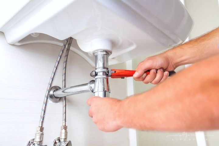 man hands fixing a sink