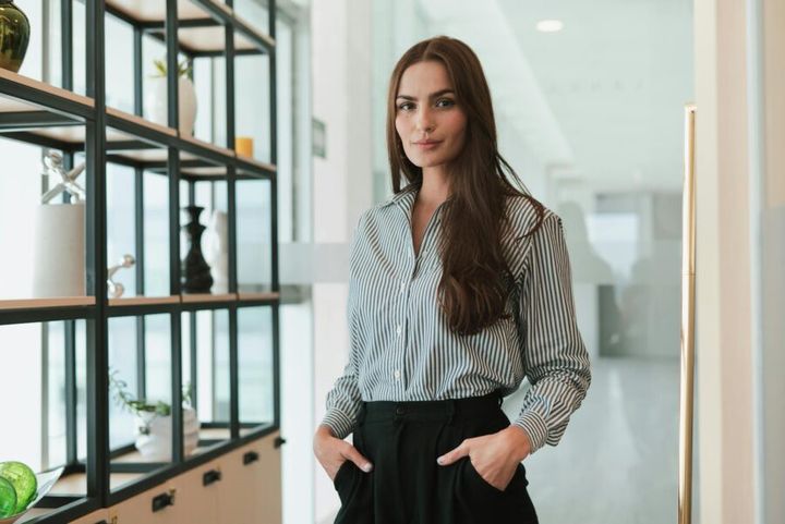 Portrait of a confident businesswoman standing in a modern office environment.