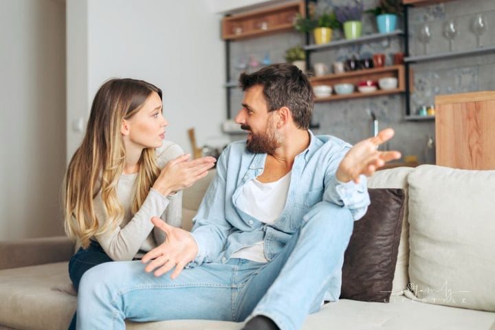 Angry couple arguing in the living room