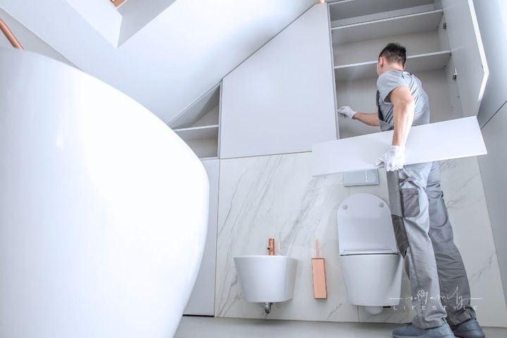 Man Installing Bathroom Interior Finishing