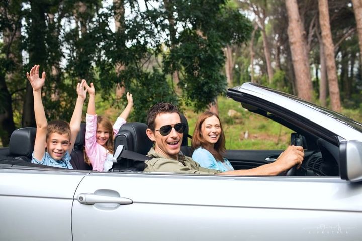 happy family on vacation in rented convertible