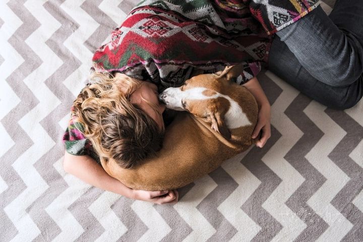 Woman Laying Down with Pet Dog