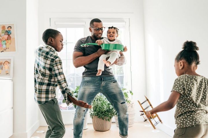 Dad and kids at home with musical instruments