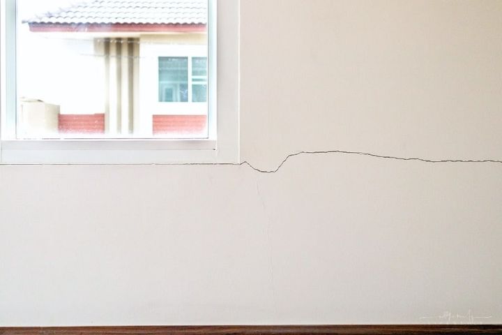 cracks in wall of house showing foundation damage