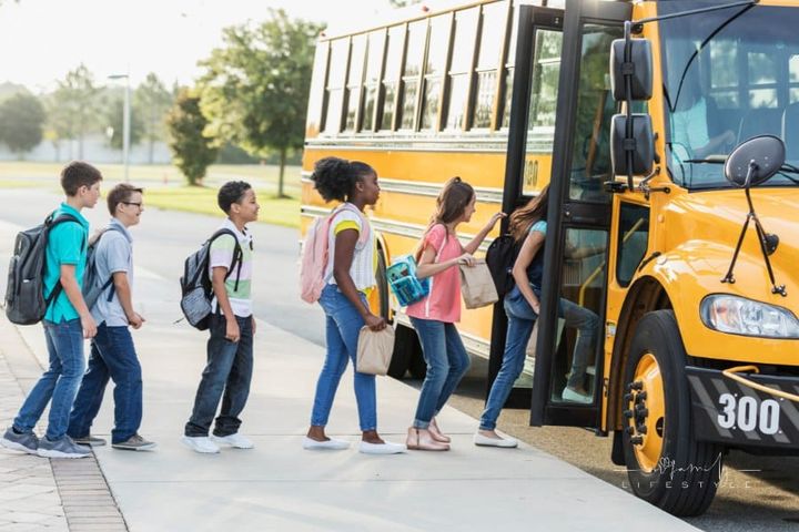 Middle school students boarding a bus