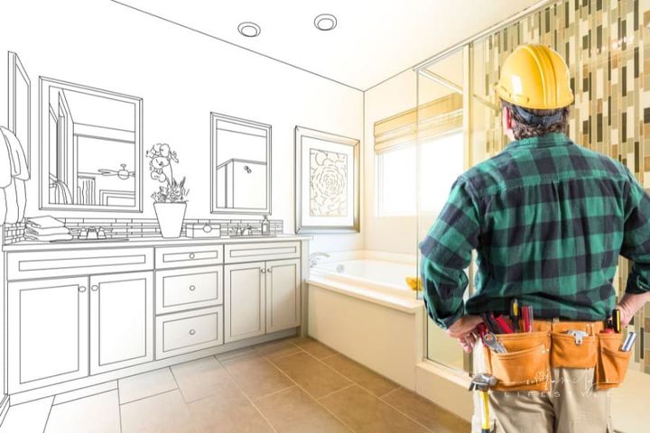 contractor envisioning master bath remodel through blueprints