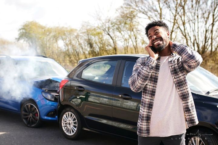 man calling insurance a car accident