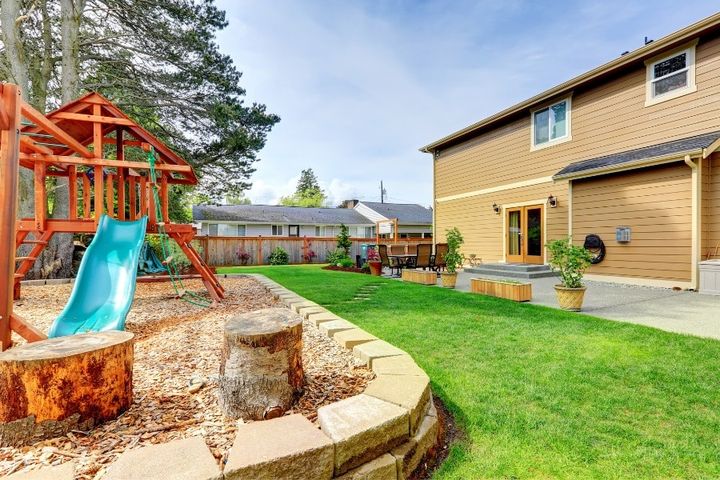 backyard with patio and playset for kids