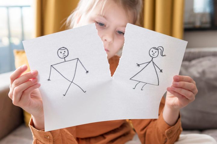 Medium shot girl holding broken drawing of stick figure couple