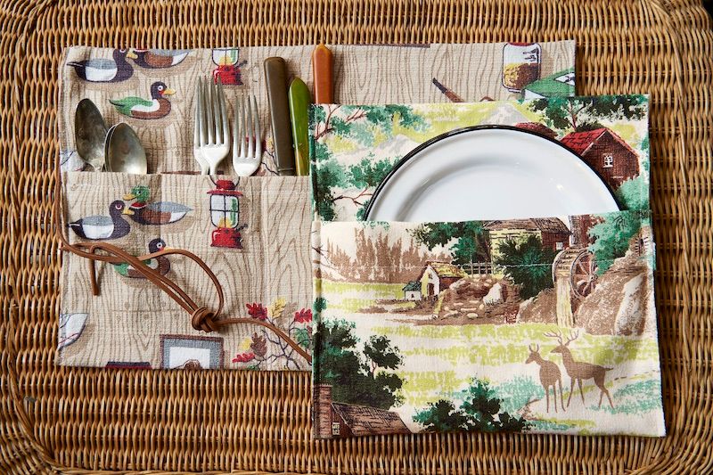 Vintage fabric made into storage cases for plates and flatware.