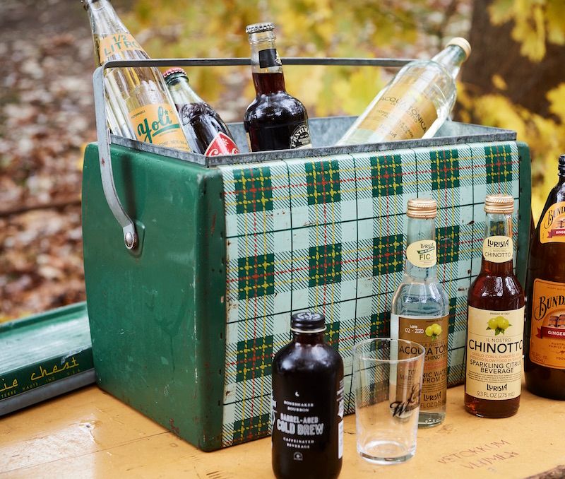 Vintage cooler filled with bottled drinks for a picnic.