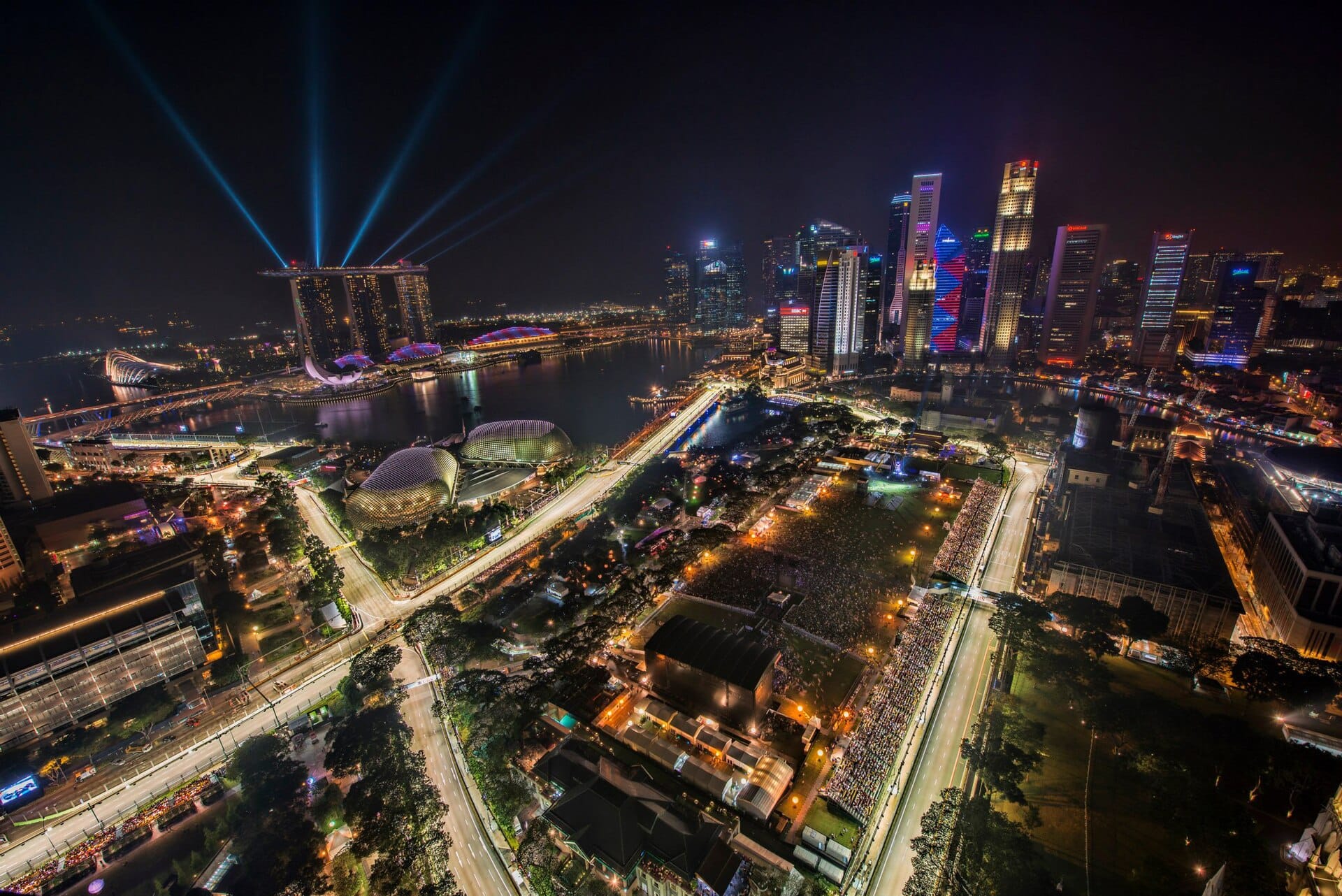 Formula 1 cars racing at night on the Marina Bay street circuit in Singapore