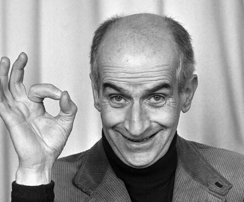 Louis de Funès faisait un signe avec sa main droite.
