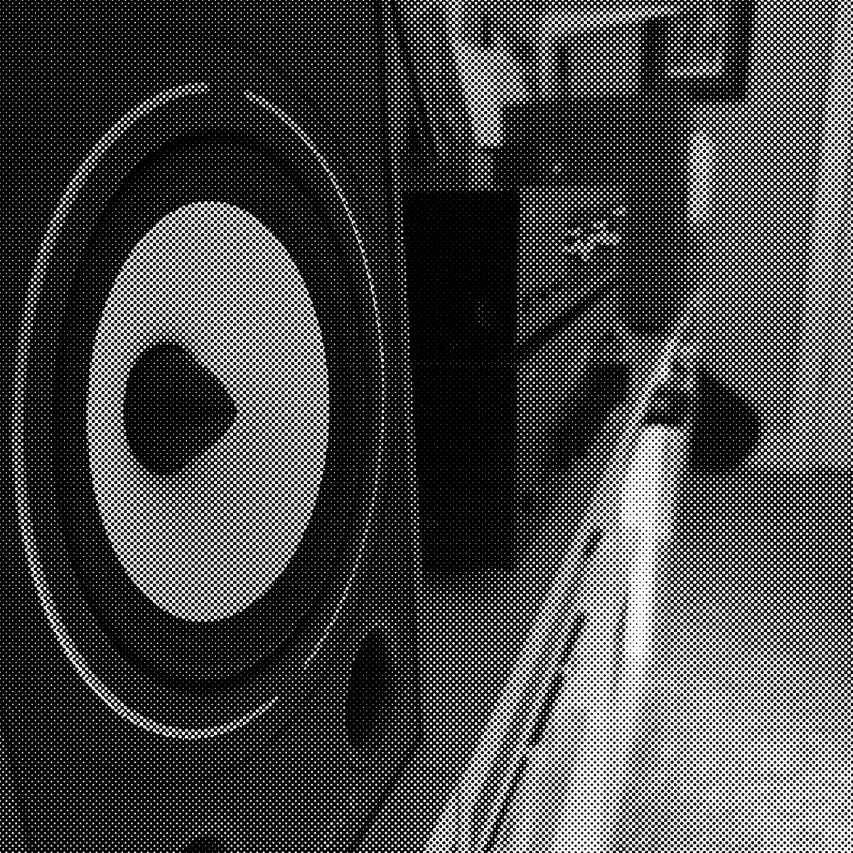 A black and white closeup image of a loudpseaker on a shelf with some other hi-fi stereo gear. 