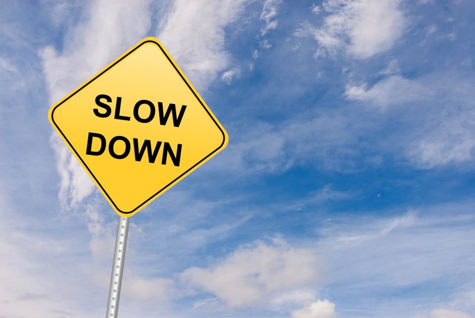 Picture of a stop sign that says "Slow Down"