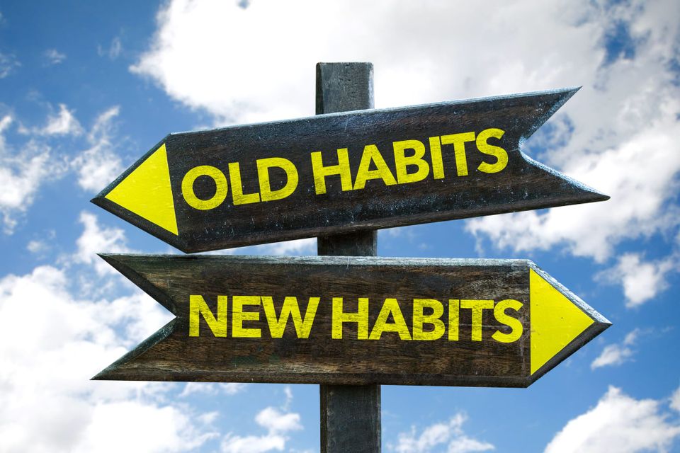 Picture of a sign with 2 arrows, one that says old habits, one that says new habits.