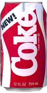 A can of New Coke, red and white, photographed against a plain background.