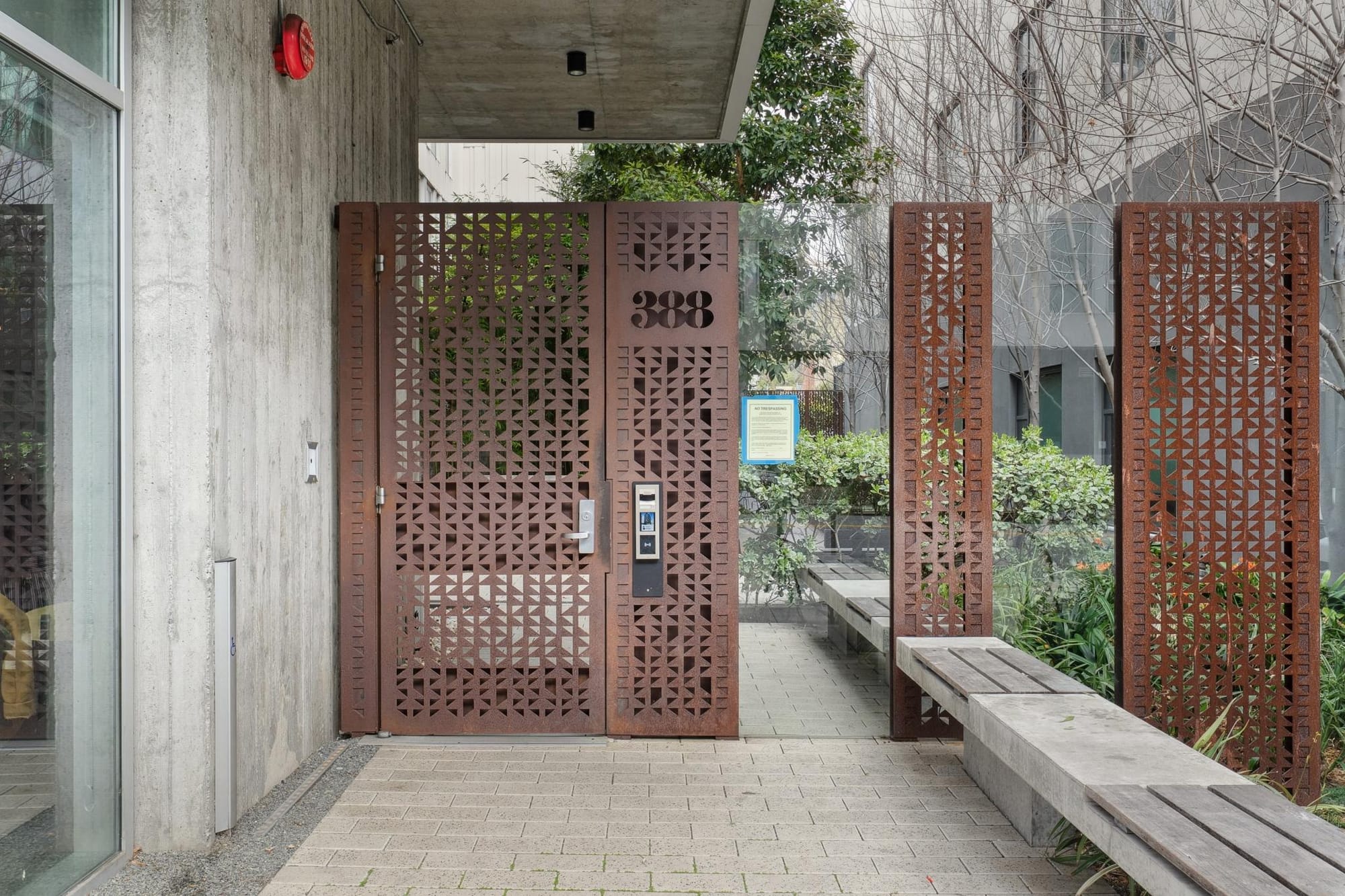 Laser-cut steel entry gate at 388 Fulton