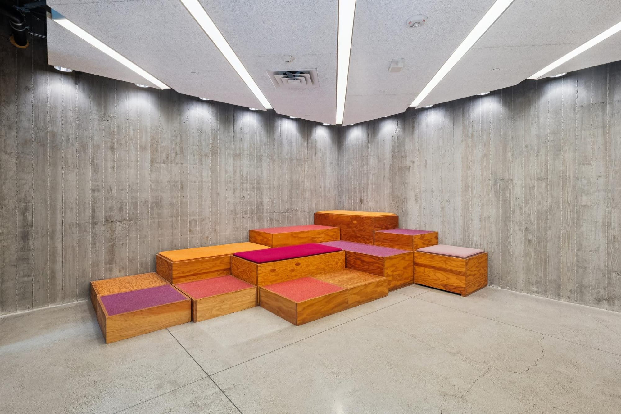 Lobby lounge with colorful tiered seating at 388 Fulton
