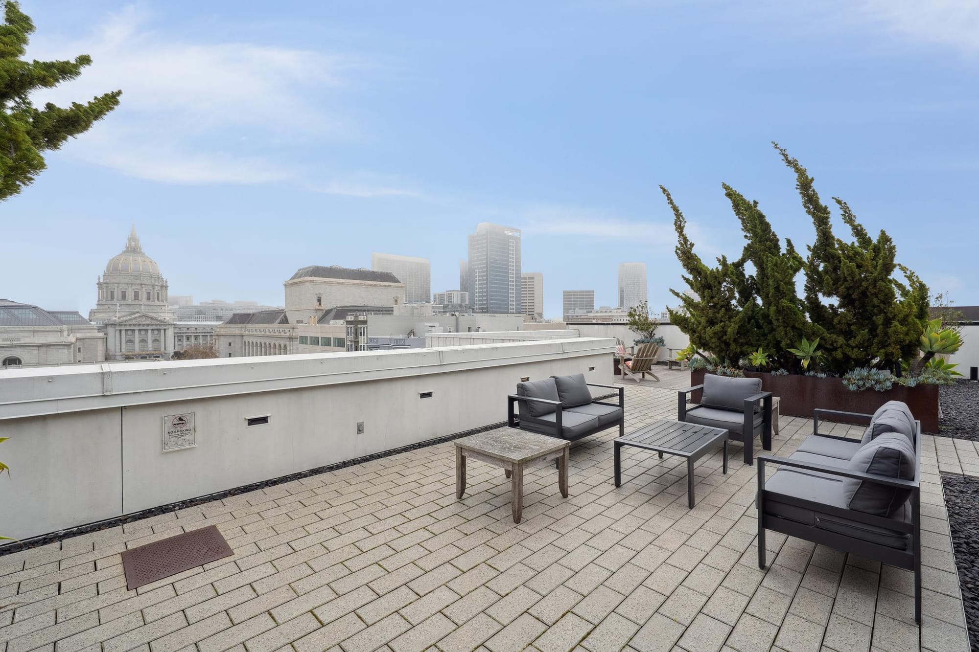 Rooftop lounge seating with City Hall view at 388 Fulton