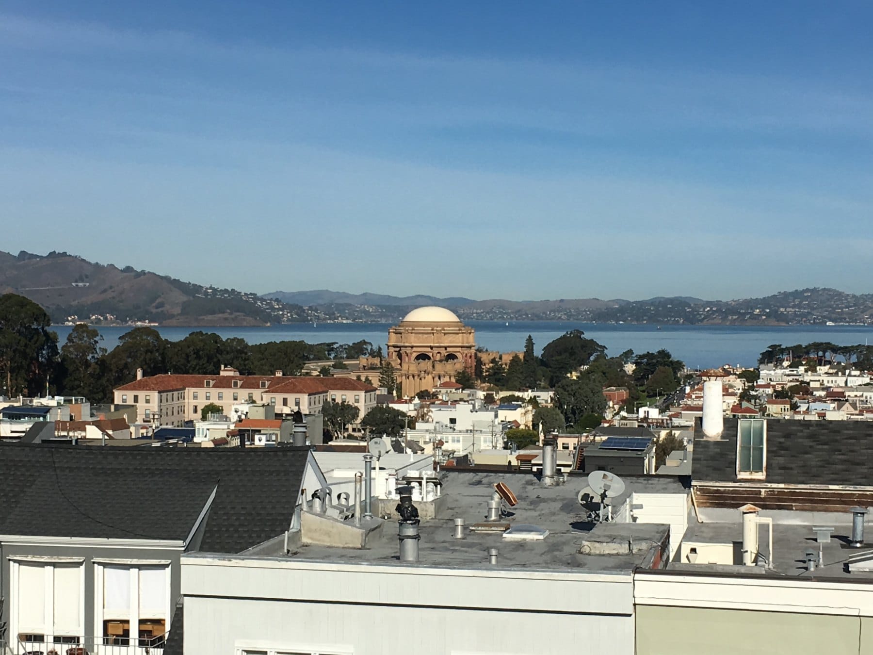 Cow Hollow rooftops with the Palace of Fine Arts dome and the bay beyond