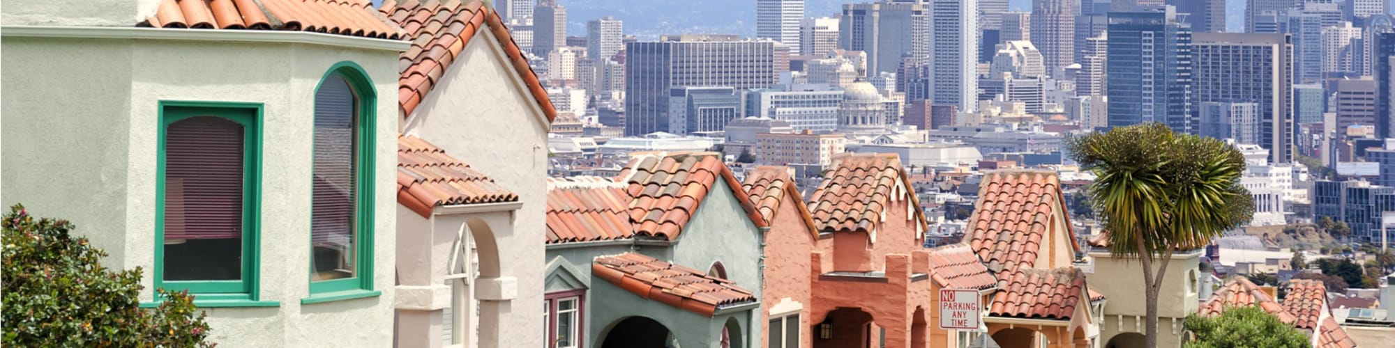 Rooflines below Twin Peaks with the downtown skyline beyond