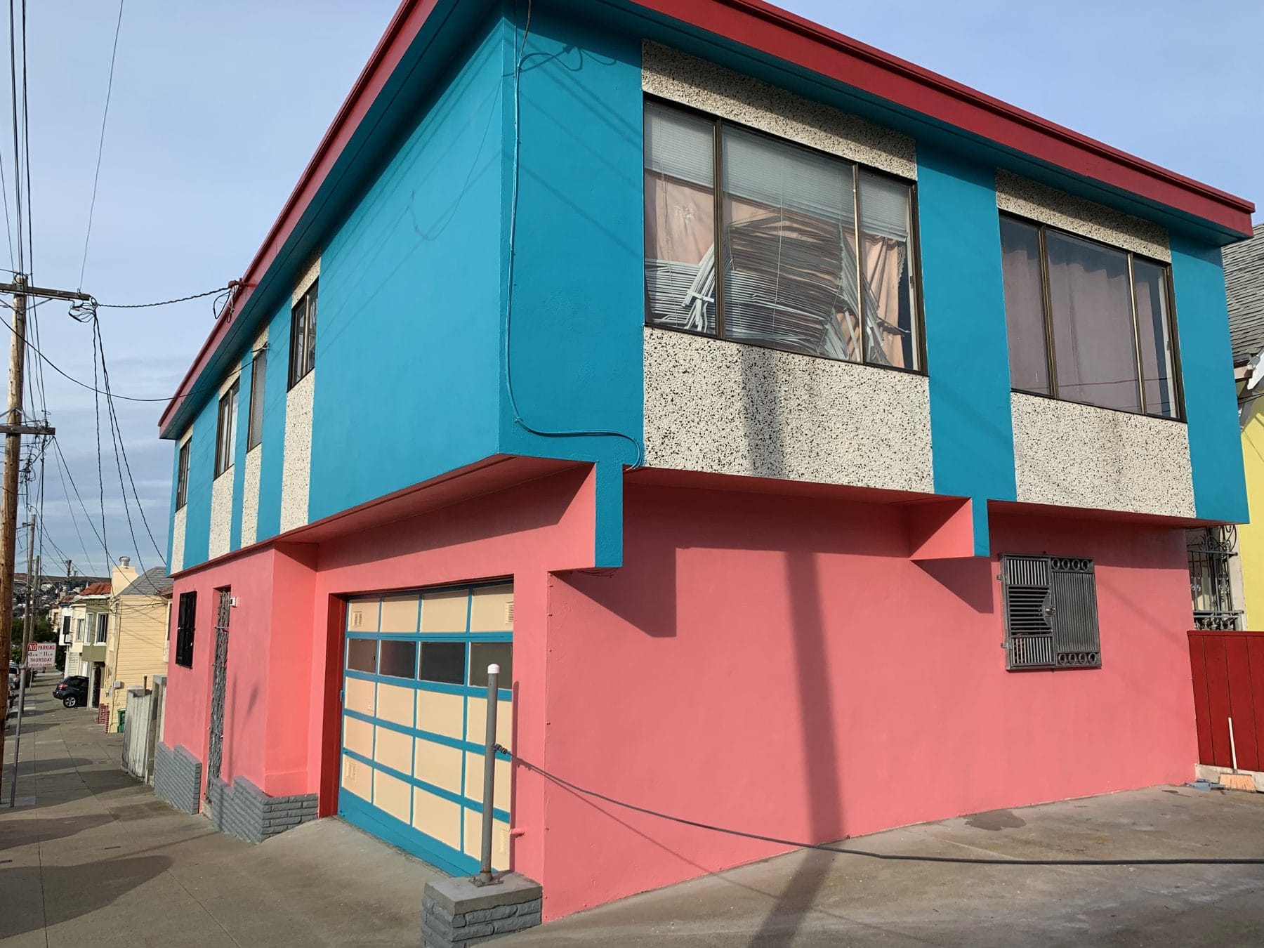 A red and turquoise house on a Portola corner