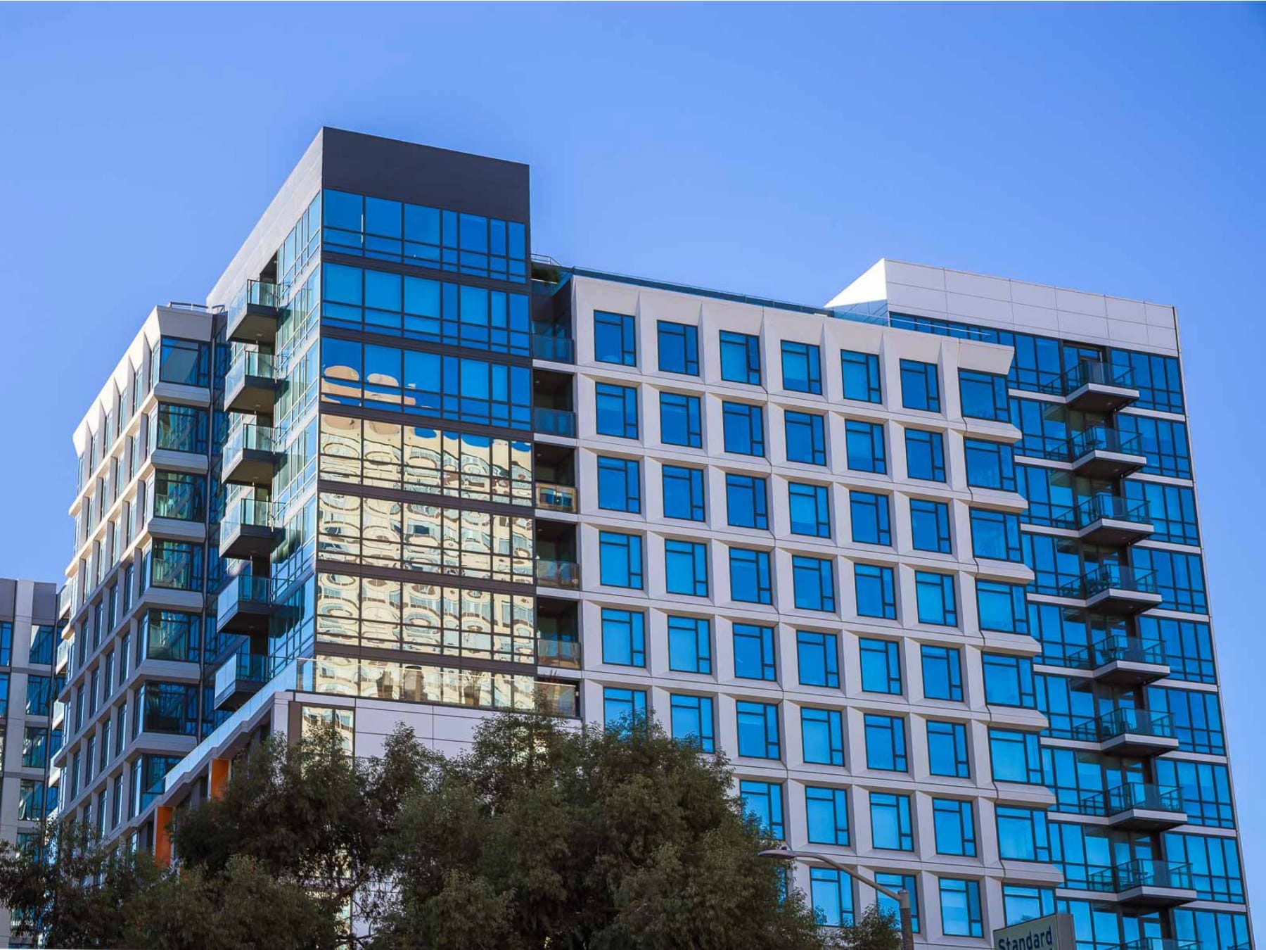 The two glass-and-white towers of The Rockwell seen from Pine Street